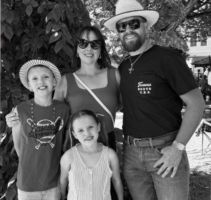 Michael and Lauren Singley with their two kids, outdoors on a sunny day.